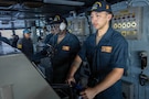U.S. CENTRAL COMMAND AREA OF RESPONSIBILITY (Jan. 27, 2026) U.S. Navy Seaman Dominic Fernandez, front, and U.S. Navy Operations Specialist Seaman Marquis Jones stand watch as helmsman and lee helmsman on the bridge aboard the Nimitz-class aircraft carrier USS Abraham Lincoln (CVN 72) in the U.S. Central Command (CENTCOM) area of responsibility, Jan. 27. Abraham Lincoln is deployed to the U.S. 5th Fleet area of operations to support maritime security and stability in the CENTCOM area of responsibility. (U.S. Navy photo by Mass Communication Specialist Seaman Samuel Evarts)