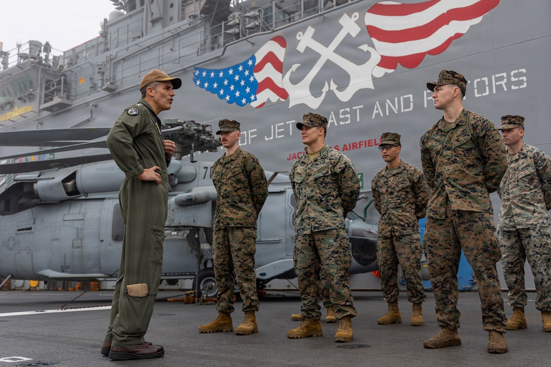 U.S. Navy Rear Adm. Carlos Sardiello, commander, U.S. Naval Forces Southern Command/U.S. Fourth Fleet, recognizes U.S. Marines with the 22nd Marine Expeditionary Unit (Special Operations Capable) during a visit to Wasp-class amphibious assault USS Iwo Jima (LHD 7) in Naval Station Mayport, Florida, Jan. 8, 2026. U.S. military forces are deployed to the Caribbean in support of the U.S. Southern Command mission, Department of War-directed operations, and the president’s priorities to disrupt illicit drug trafficking and protect the homeland. (U.S. Marine Corps photo)