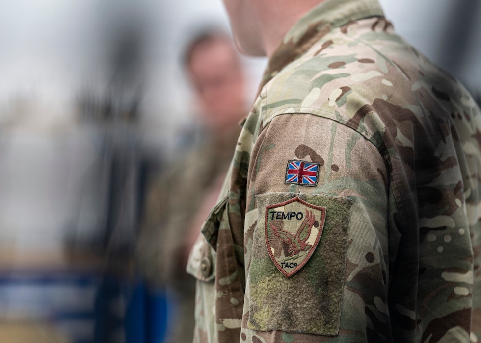 U.S. Air Force Tech. Sgt. Will Knutson, 820th Base Defense Group deployable radio frequency non-commissioned officer in charge, talks with a British Armed Forces member at Moody Air Force Base, Georgia, Jan. 15, 2026. The discussion gave U.S. and U.K. personnel the chance to share communication techniques, compare equipment and exchange lessons learned to enhance mission readiness. (U.S. Air Force photo by Senior Airman Leonid Soubbotine)