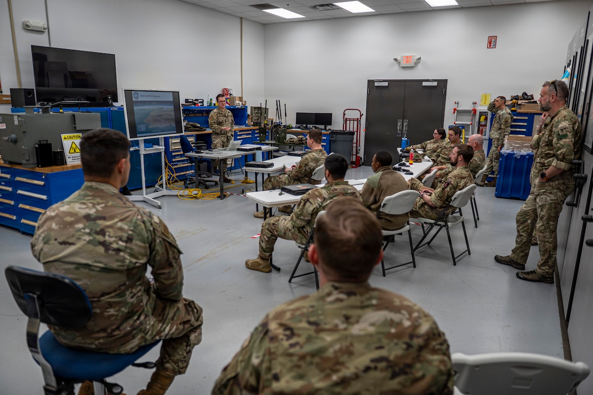 U.S. Air Force Tech. Sgt. Will Knutson, 820th Base Defense Group deployable radio frequency non-commissioned officer in charge, delivers a presentation to Airmen assigned to the 820th BDG and British Armed Forces members at Moody Air Force Base, Georgia, Jan. 15, 2026. The presentation highlighted knowledge sharing and collaboration between allied forces. (U.S. Air Force photo by Senior Airman Leonid Soubbotine)