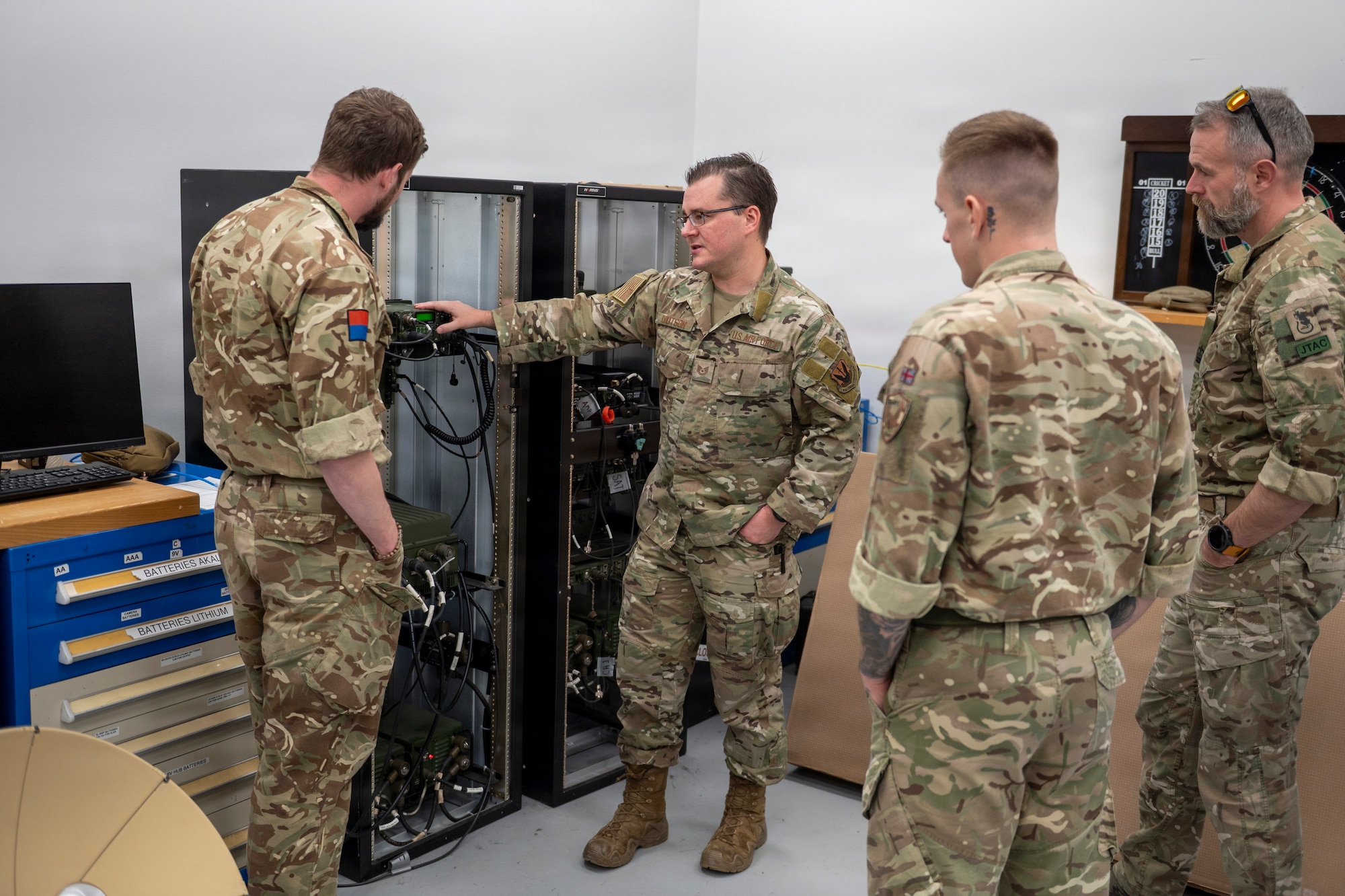 U.S. Air Force Tech. Sgt. Will Knutson, 820th Base Defense Group deployable radio frequency non-commissioned officer in charge, shares information on communication equipment used by 820th BDG with British Armed Forces members at Moody Air Force Base, Georgia, Jan. 15, 2026. U.S. and U.K. service members exchanged insights and experiences to better understand each other’s equipment and procedures. (U.S. Air Force photo by Senior Airman Leonid Soubbotine)