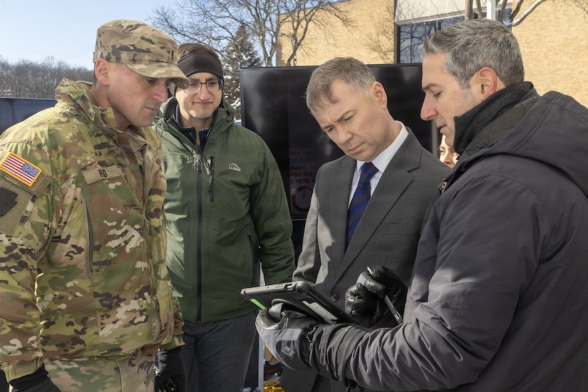 Chief Warrant Officer 3 Robert Reed, left, of the Pennsylvania National Guard Unmanned Aircraft Systems Training and Innovation Facility takes part a UAS demonstration for Brent Ingraham, third from left, Assistant Secretary of the Army for Acquisition, Logistics, and Technology and Army Acquisition Executive, Jan. 20, 2026 at Picatinny Arsenal, New Jersey. (U.S. Army photo by Todd Mozes)
