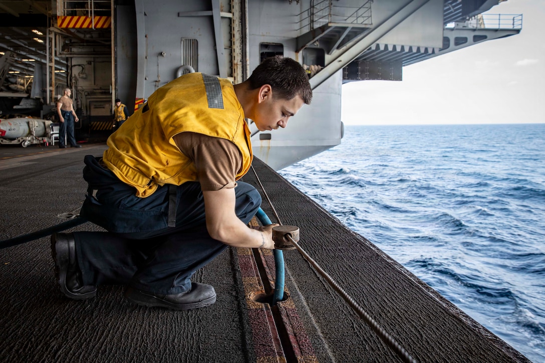 U.S. CENTRAL COMMAND AREA OF RESPONSIBILITY (Jan. 26, 2026) U.S. Navy Fireman Almon Loos refills oil for an aircraft elevator in the hangar bay of the Nimitz-class aircraft carrier USS Abraham Lincoln (CVN 72) in the U.S. Central Command (CENTCOM) area of responsibility, Jan. 26. Abraham Lincoln is deployed to the U.S. 5th Fleet area of operations to support maritime security and stability in the CENTCOM area of responsibility. (U.S. Navy photo by Mass Communication Specialist Seaman Aljay Monzales)
