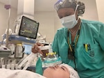 Anesthetist covers patient nose with oxygen mask prior to surgery.