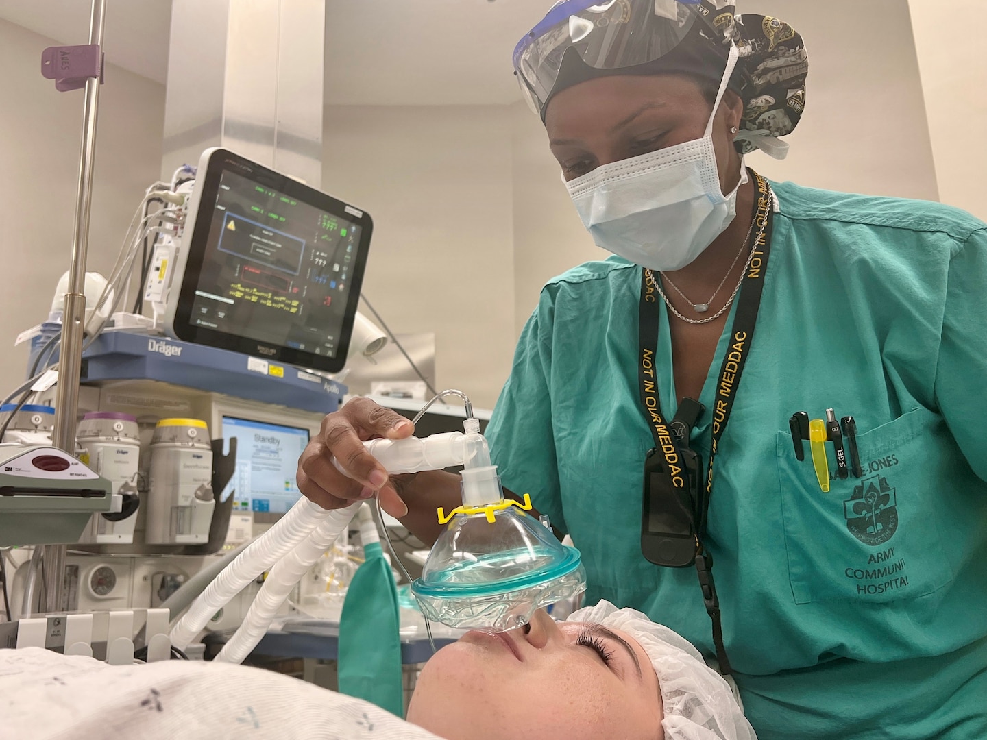 Anesthetist covers patient nose with oxygen mask prior to surgery.