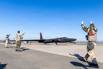 U-2 sitting on flightline with Airmen