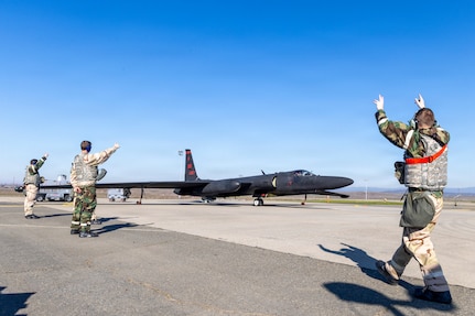U-2 sitting on flightline with Airmen