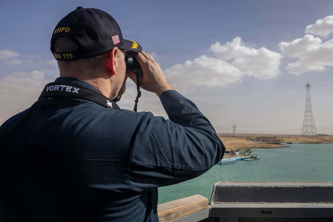 SUEZ CANAL (Jan. 28, 2026) – U.S. Navy Cmdr. Ezra Hatch, commanding officer of Arleigh Burke-class guided-missile destroyer USS Delbert D. Black (DDG 119), looks through binoculars as the ship transits the Suez Canal, Jan. 28. Delbert D. Black is deployed to the U.S. 5th Fleet area of operations to support maritime security and stability in the U.S. Central Command area of responsibility. (U.S. Navy photo by Mass Communication Specialist 1st Class Wendy Arauz)