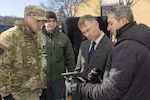 Chief Warrant Officer 3 Robert Reed, left, of the Pennsylvania National Guard Unmanned Aircraft Systems Training and Innovation Facility takes part in an unmanned aircraft systems demonstration for Assistant Secretary of the Army for Acquisition, Logistics, and Technology and Army Acquisition Executive Brent Ingraham, third from left, Jan. 20, 2026 at Picatinny Arsenal, New Jersey. Photo by Todd Mozes.