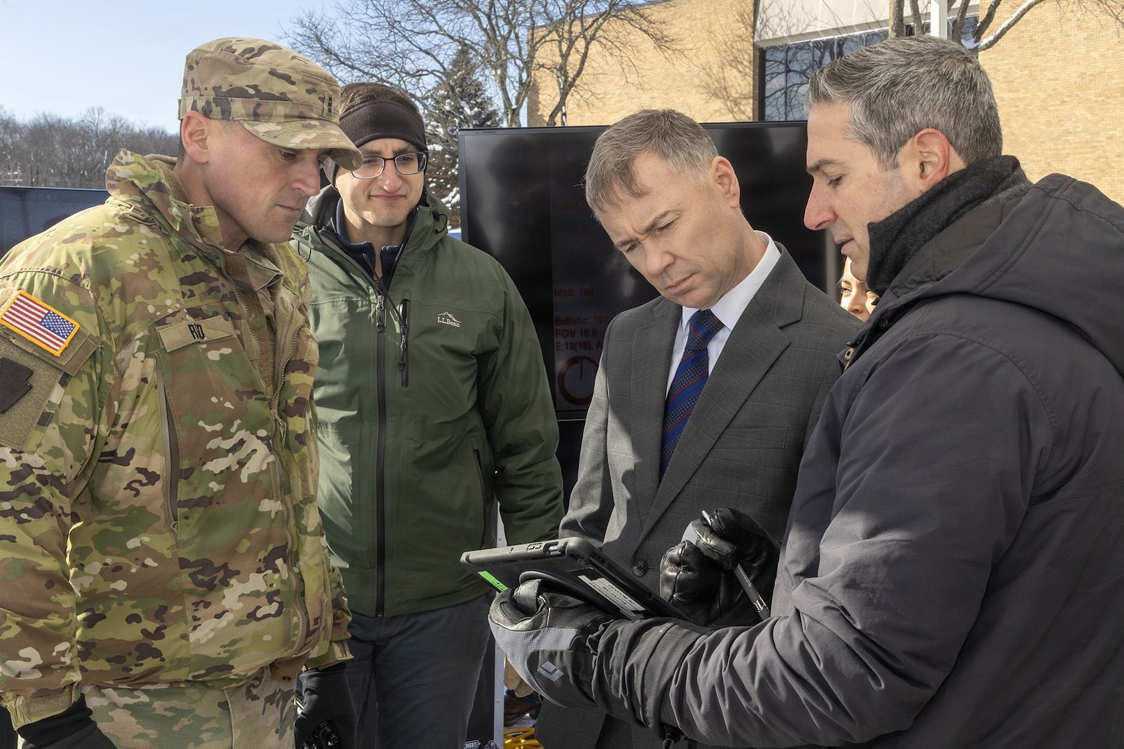 Chief Warrant Officer 3 Robert Reed, left, of the Pennsylvania National Guard Unmanned Aircraft Systems Training and Innovation Facility takes part in an unmanned aircraft systems demonstration for Assistant Secretary of the Army for Acquisition, Logistics, and Technology and Army Acquisition Executive Brent Ingraham, third from left, Jan. 20, 2026 at Picatinny Arsenal, New Jersey.