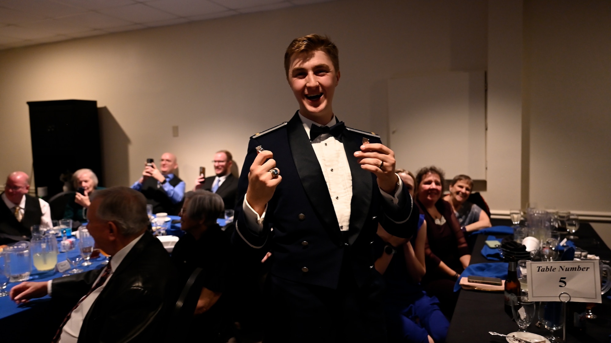 U.S. Air Force Airmen from graduating Class 26-05 break their wings at Laughlin Air Force Base, Texas, Jan. 29, 2026. Twenty-nine U.S. and Romanian Air Force officers were awarded silver wings during the ceremony, symbolizing their completion of the Undergraduate Pilot Training program. (U.S. Air Force photo by Airman 1st Class Harrison Sullivan)