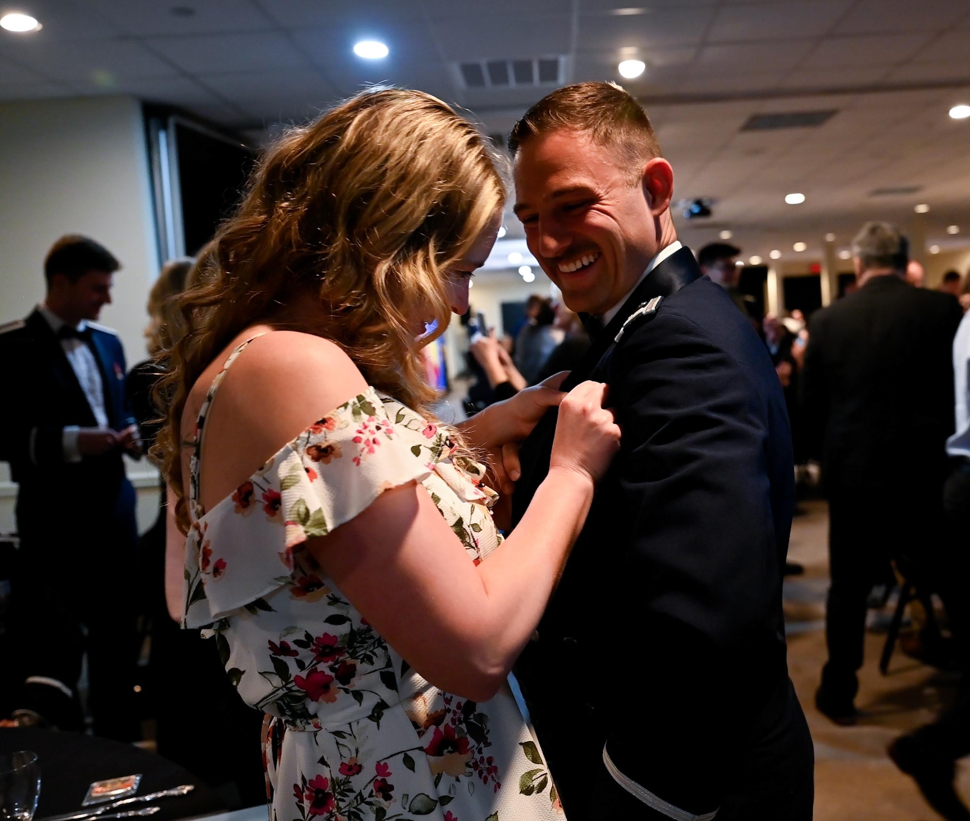 Loved ones pin silver wings on their graduate during a graduation ceremony of Class 26-02 at Laughlin Air Force Base, Texas, Oct. 30, 2025. Twenty-nine U.S. Air Force and Slovak officers were awarded silver wings during the ceremony, symbolizing their completion of the Undergraduate Pilot Training program. (U.S. Air Force photo by Airman 1st Class Harrison Sullivan)