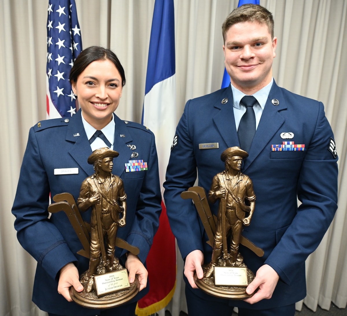 Texas Air National Guard 2nd Lt. Jericka Graves, left, and Senior Airman Lance Devillier, right, pose with their Outstanding Airman of the Year trophies, Jan. 11, 2026.