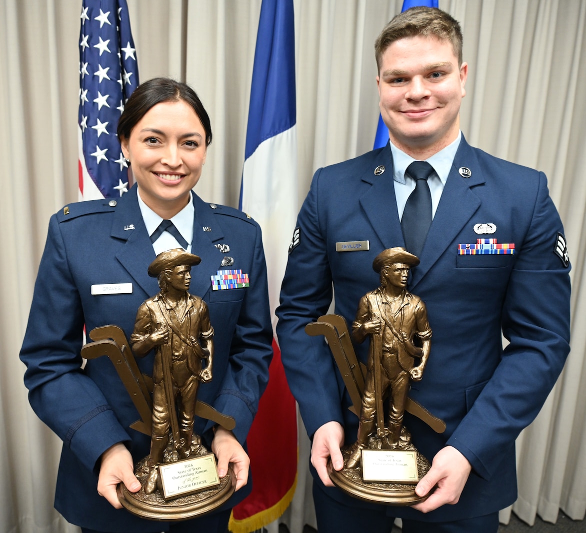 Texas Air National Guard 2nd Lt. Jericka Graves, left, and Senior Airman Lance Devillier, right, pose with their Outstanding Airman of the Year trophies, Jan. 11, 2026.