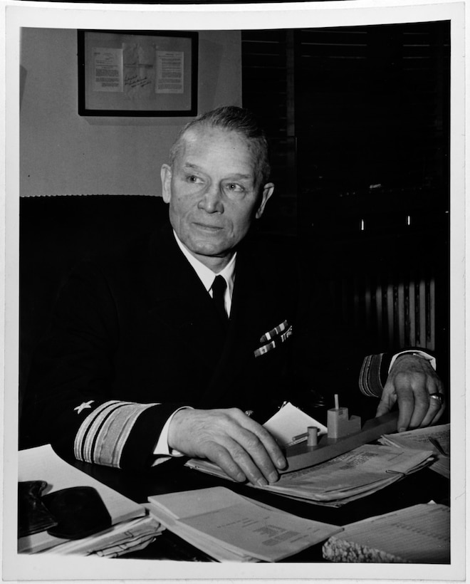 Vice Admiral Emory S. Land, USN, seated at his desk. (U.S. Navy photo, Naval History and Heritage Command)