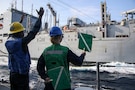 U.S. CENTRAL COMMAND AREA OF RESPONSIBILITY (Jan. 26, 2026) U.S. Navy Boatswain’s Mate 3rd Class Artez Patterson, left, and U.S. Navy Seaman Apprentice Catherine Armitage use signals to load cargo aboard Arleigh Burke-class guided-missile destroyer USS Frank E. Petersen Jr. (DDG 121) during a replenishment-at-sea with Henry J. Kaiser-class fleet replenishment oiler USNS Henry J. Kaiser (T-AO-187) in the U.S. Central Command (CENTCOM) area of responsibility. Frank E. Petersen Jr. is deployed to the U.S. 5th Fleet area of operations to support maritime security and stability in the CENTCOM area of responsibility. (U.S. Navy photo by Mass Communication Specialist 2nd Class Christian Kibler)