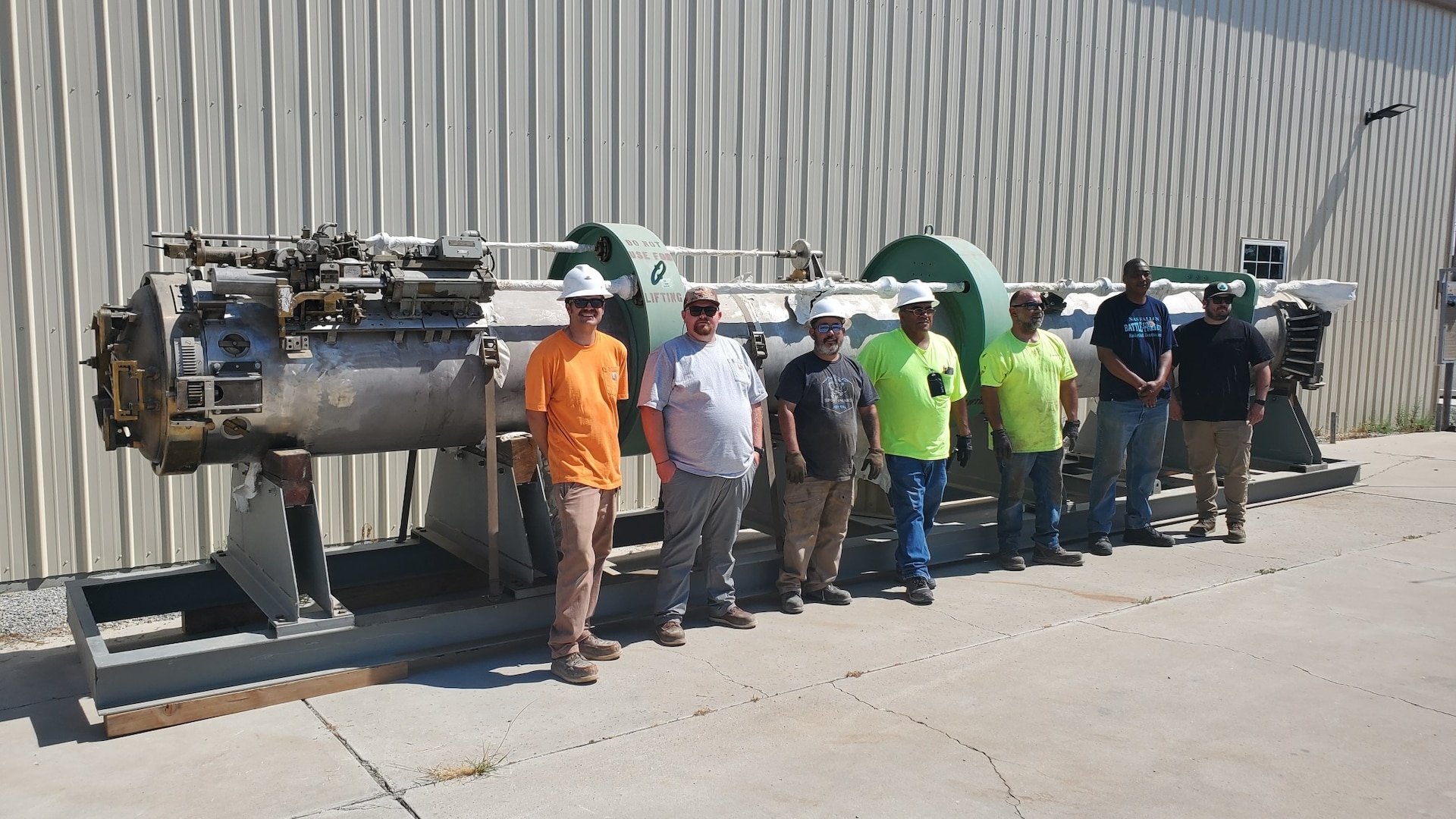 Employees of Naval Undersea Warfare Center Division, Keyport Hawthorne Detachment and members of the operating contractor for Hawthorne Army Depot, pose in front of a mock submarine torpedo tube prototype. The U.S. Department of Defense donated the tube, originally built for a proposed submarine upgrade, to the museum. Left to right: Dakota Baker, Garth Price, Mike Legg, Paul Trujillo, Carlos Isom, Tevis Jones, and Brodie MacPherson. (U.S. Navy photo by Tony Hughes/Released)