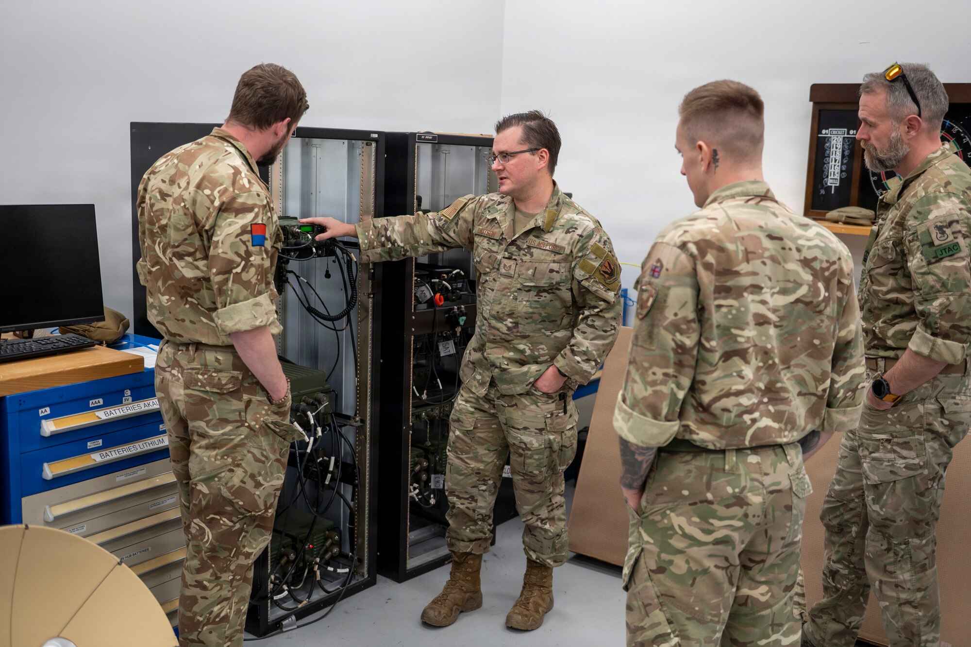 U.S. Air Force Tech. Sgt. Will Knutson, 820th Base Defense Group deployable radio frequency non-commissioned officer in charge, shares information on communication equipment used by 820th BDG with British Armed Forces members at Moody Air Force Base, Georgia, Jan. 15, 2026. U.S. and U.K. service members exchanged insights and experiences to better understand each other’s equipment and procedures. (U.S. Air Force photo by Senior Airman Leonid Soubbotine)