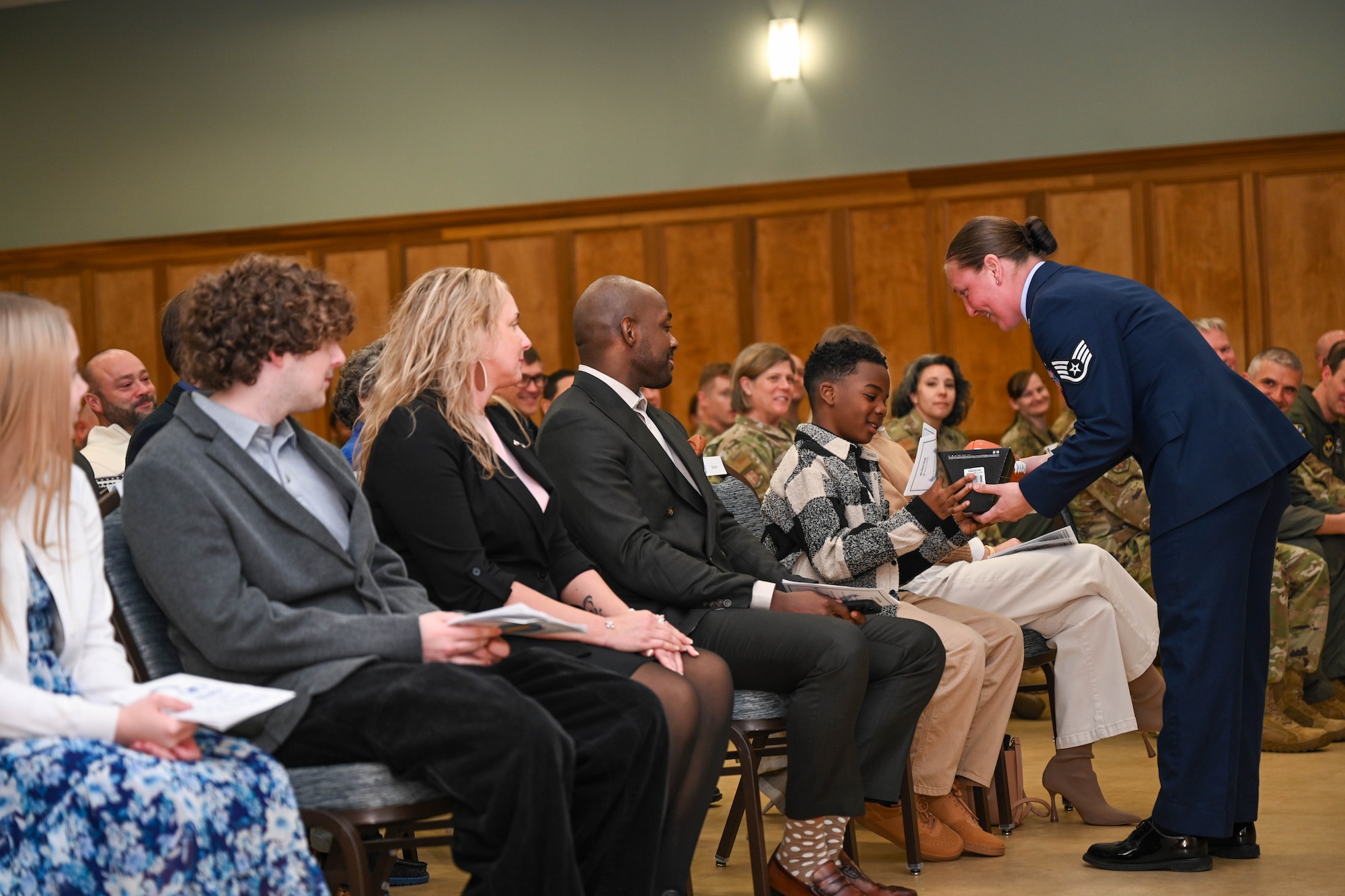 A child is given a football.