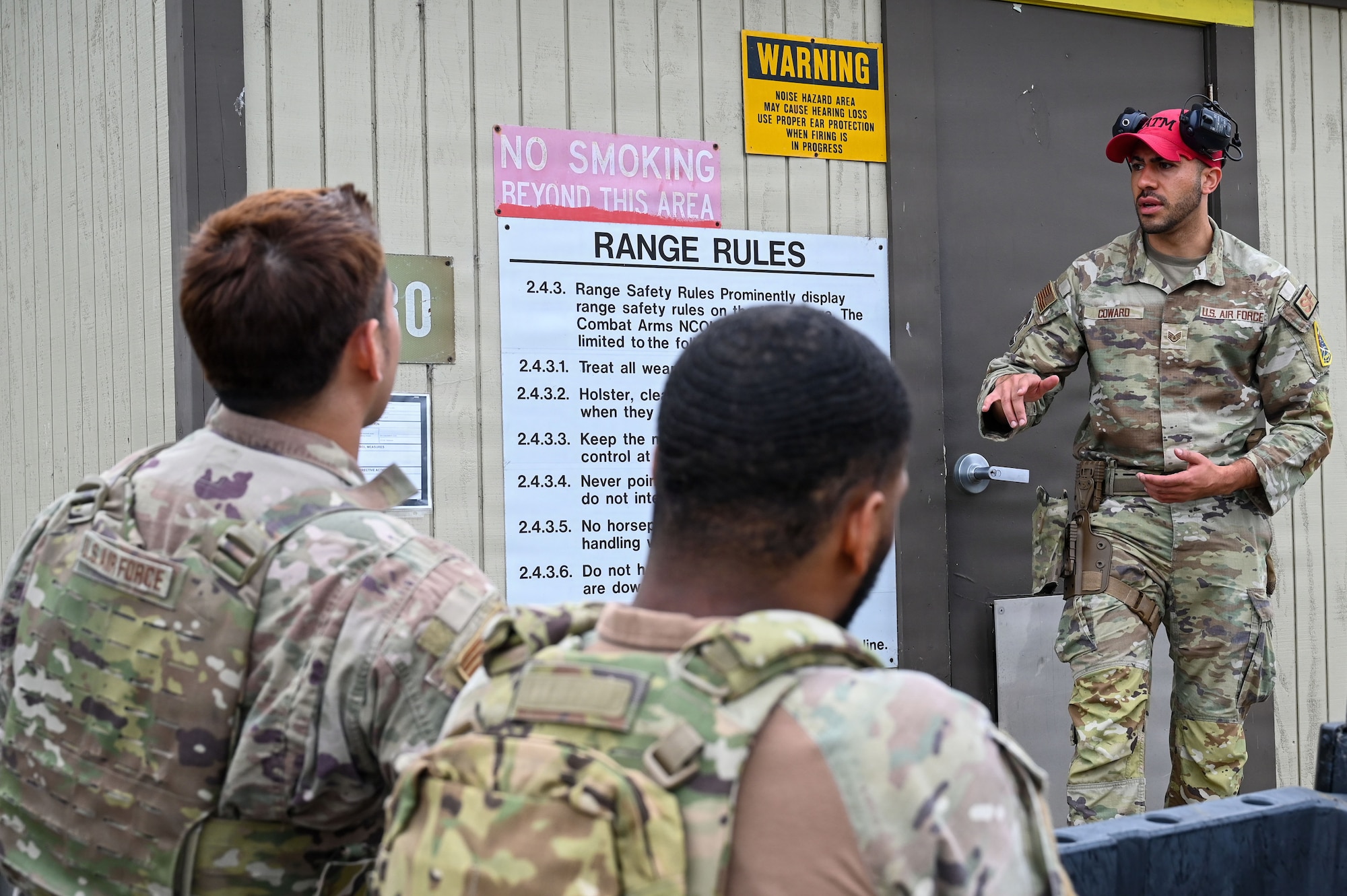 a person stands on a podium and talks about firing range rules