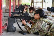 a person in a prone position fires a rifle at a firing range