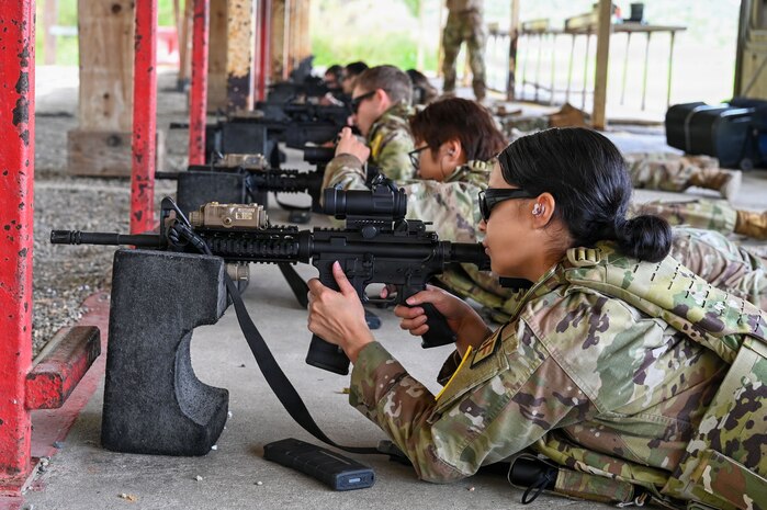 a person in a prone position fires a rifle at a firing range