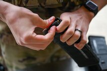a person loads rounds into a rifle magazine