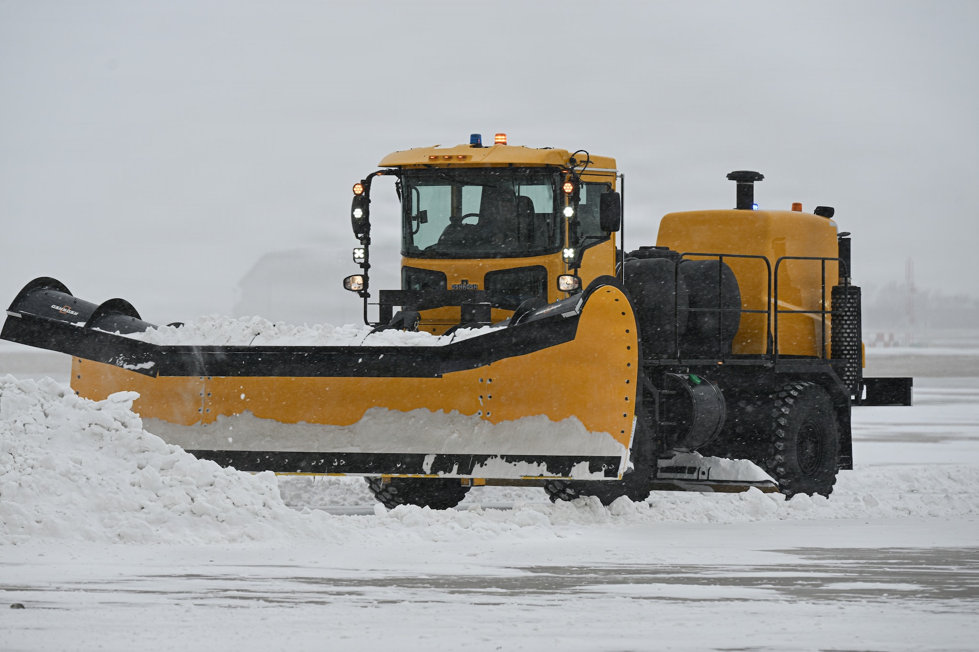 Airmen assigned to the 22nd Civil Engineer Squadron plow snow at McConnell Air Force Base, Kansas, Jan. 24., 2026.  CE members cleared the airfield to reduce snow accumulation and restore normal operations. (U.S. Air Force photo by Senior Airman Amelio Brown)