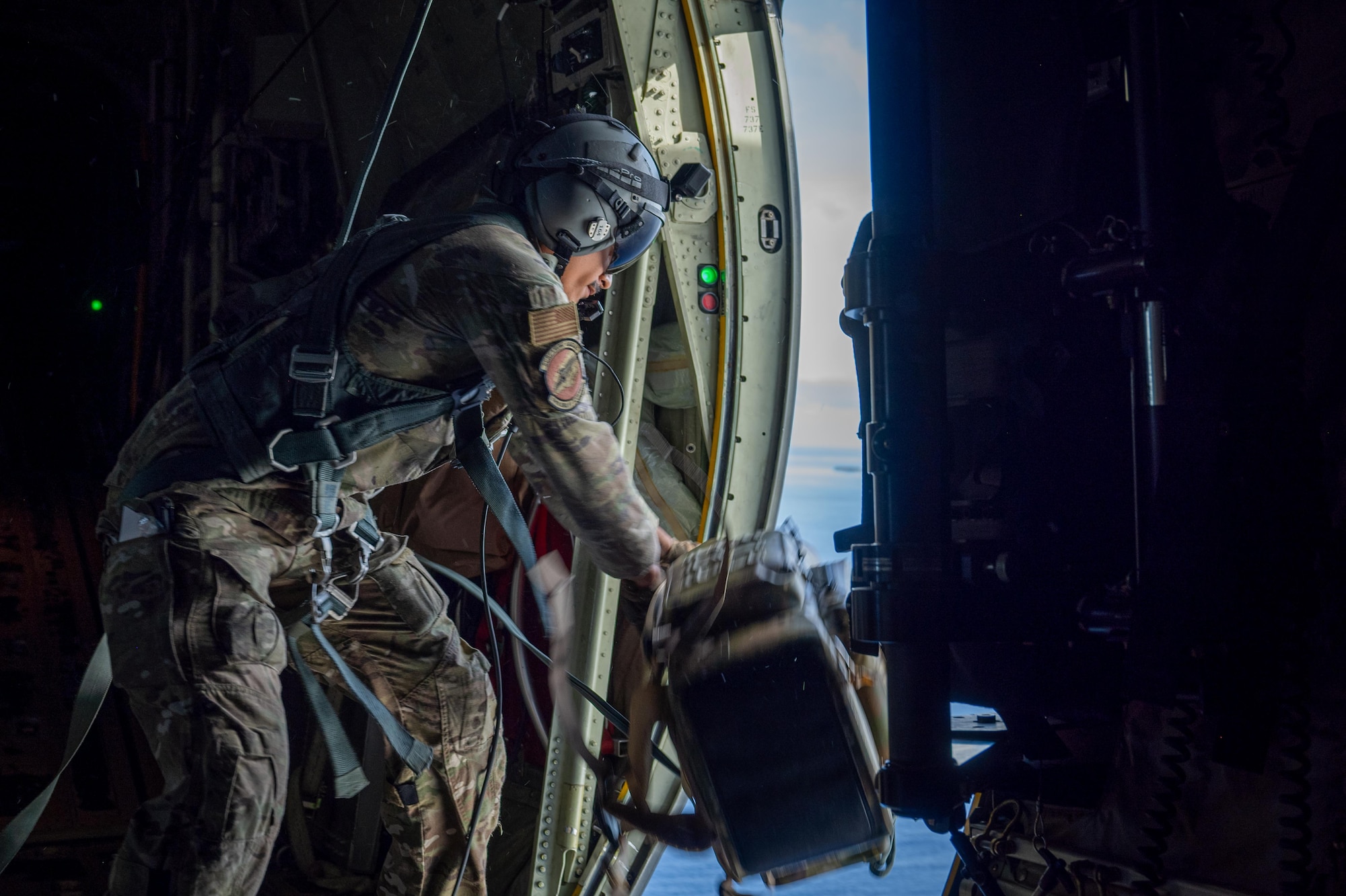 U.S. Air Force Airman 1st Class David Wiley, 40th Airlift Squadron loadmaster, conducts an airdrop from a C-130J Super Hercules during Exercise Palmetto Reach near Saipan, Northern Mariana Islands, Jan. 19, 2026. The exercise provided the 317th Airlift Wing an opportunity to rapidly deploy, generate and sustain tactical airlift while operating in austere and contested environments across the Indo-Pacific. (U.S. Air Force photo by Airman 1st Class Adrien Tran)