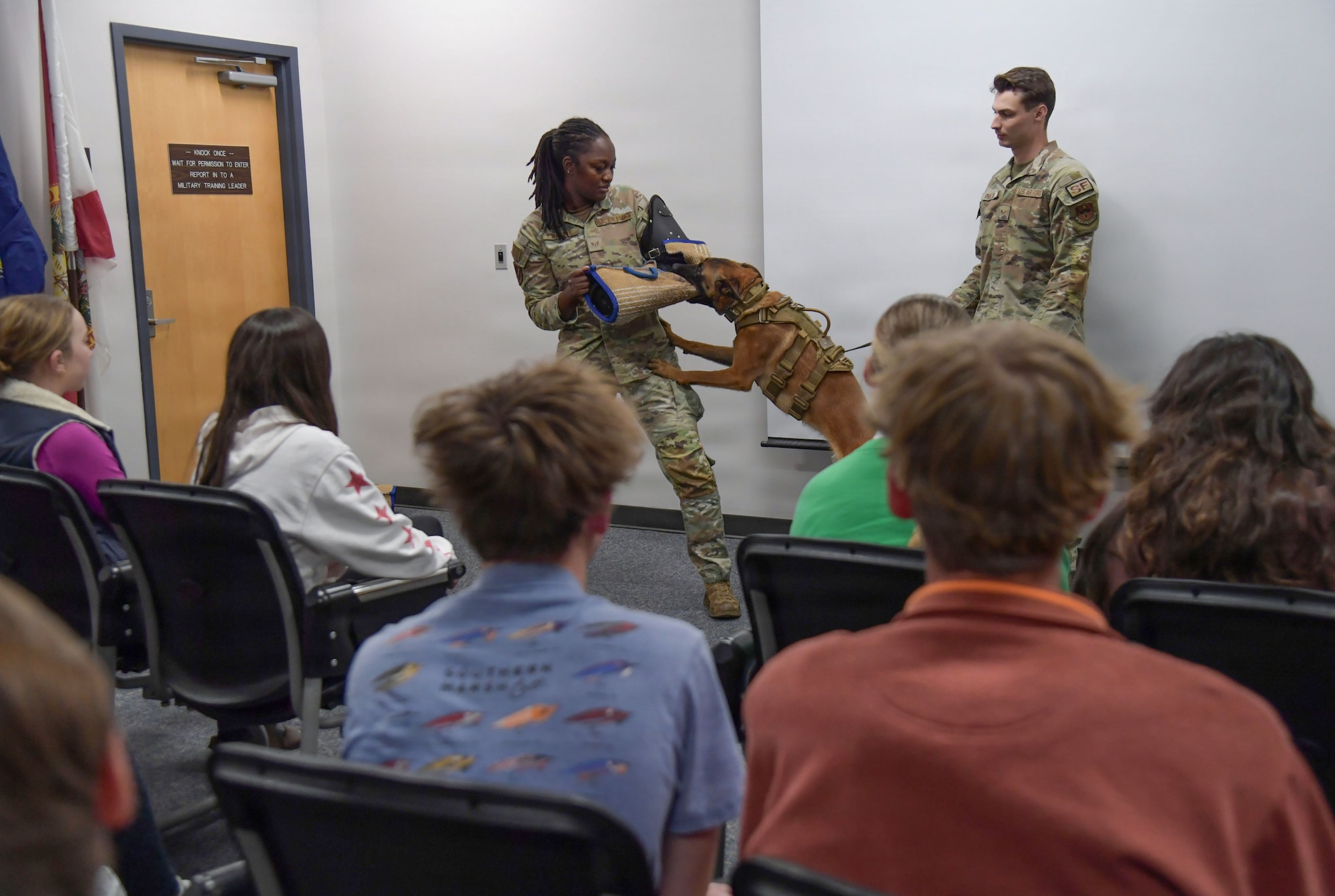Students watch a military working dog demonstration.
