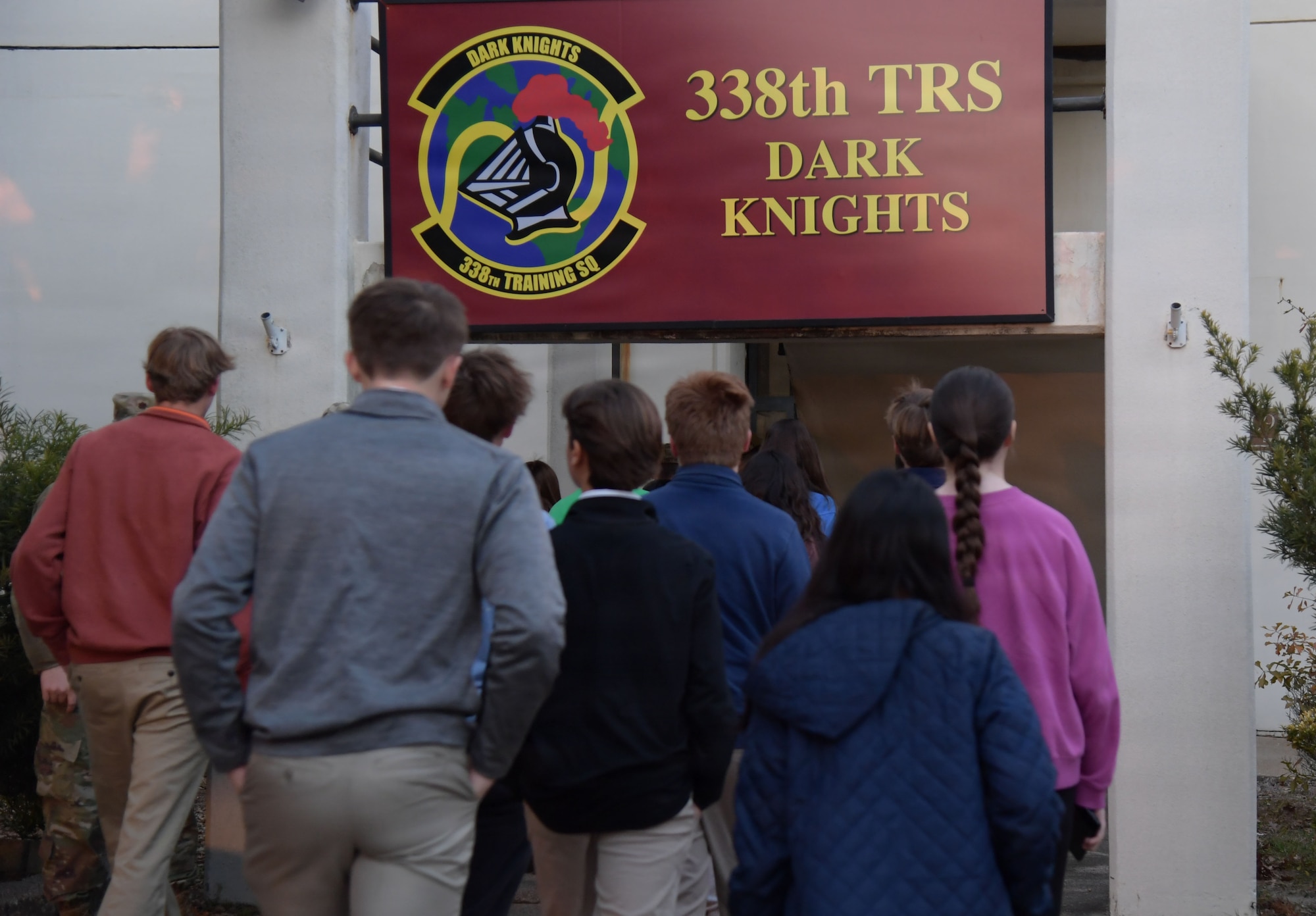 A group of students walk inside a building