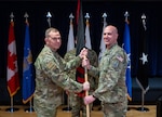 Gen. Gregory Guillot, North American Aerospace Defense Command and U.S. Northern Command commander passes the guidon emblazoned with the Space Forces-Northern emblem to Brig. Gen. Robert Schreiner, SPACEFOR-NORTH commander during the SPACEFOR-NORTH activation ceremony at Peterson SFB, Colo., Jan 30, 2026. U.S. Space Forces Northern, serves as the Space Force service component to U.S. Northern Command. (U.S. Space Force photo by John Ayre)
