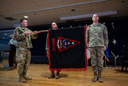 Chief Master Sergeant Seth Hogan, Command Senior Enlisted Leader Space Forces Northern unfurls the SPACEFOR-NORTH guidon during the SPACEFOR-NORTH activation ceremony at Peterson SFB, Colo., Jan 30, 2026. U.S. Space Forces Northern, serves as the Space Force service component to U.S. Northern Command. (U.S. Space Force photo by John Ayre)