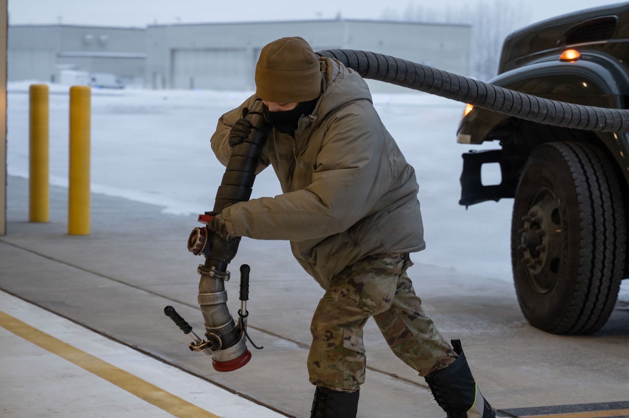 U.S. Air Force Senior Airman Ethan Perotti, 354th Logistics Readiness Squadron fuels distribution operator, pulls a fuel hose to refuel an F-35A Lightning II, assigned to the 356th Fighter Squadron at Eielson Air Force Base, Alaska, Jan. 26, 2026.