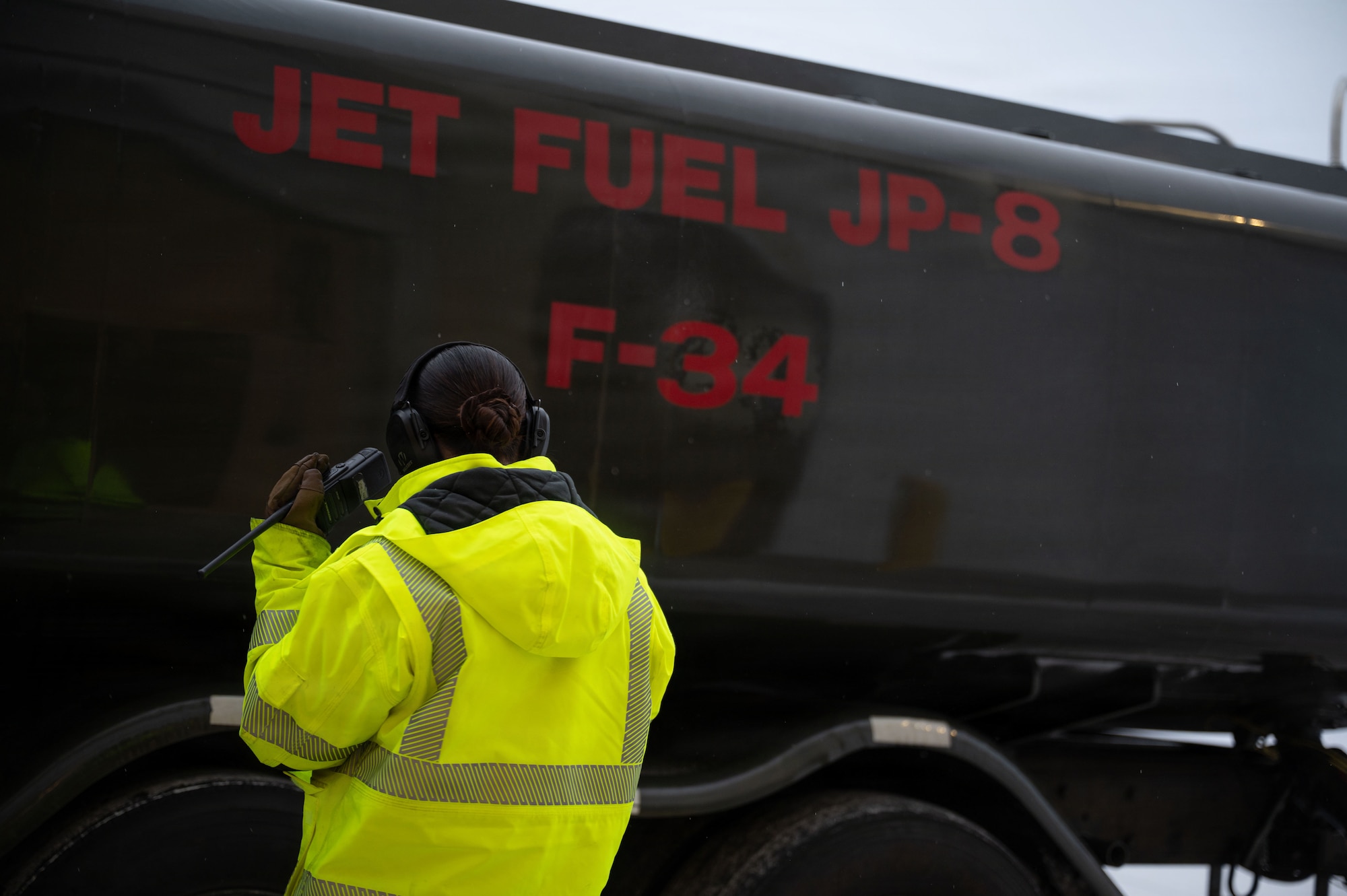 U.S. Air Force Senior Airman Kaylyn Cox, 354th Logistics Readiness Squadron fuels distribution operator, coordinates with the Fuels Service Center on her radio at Eielson Air Force Base, Alaska, Jan. 26, 2026.