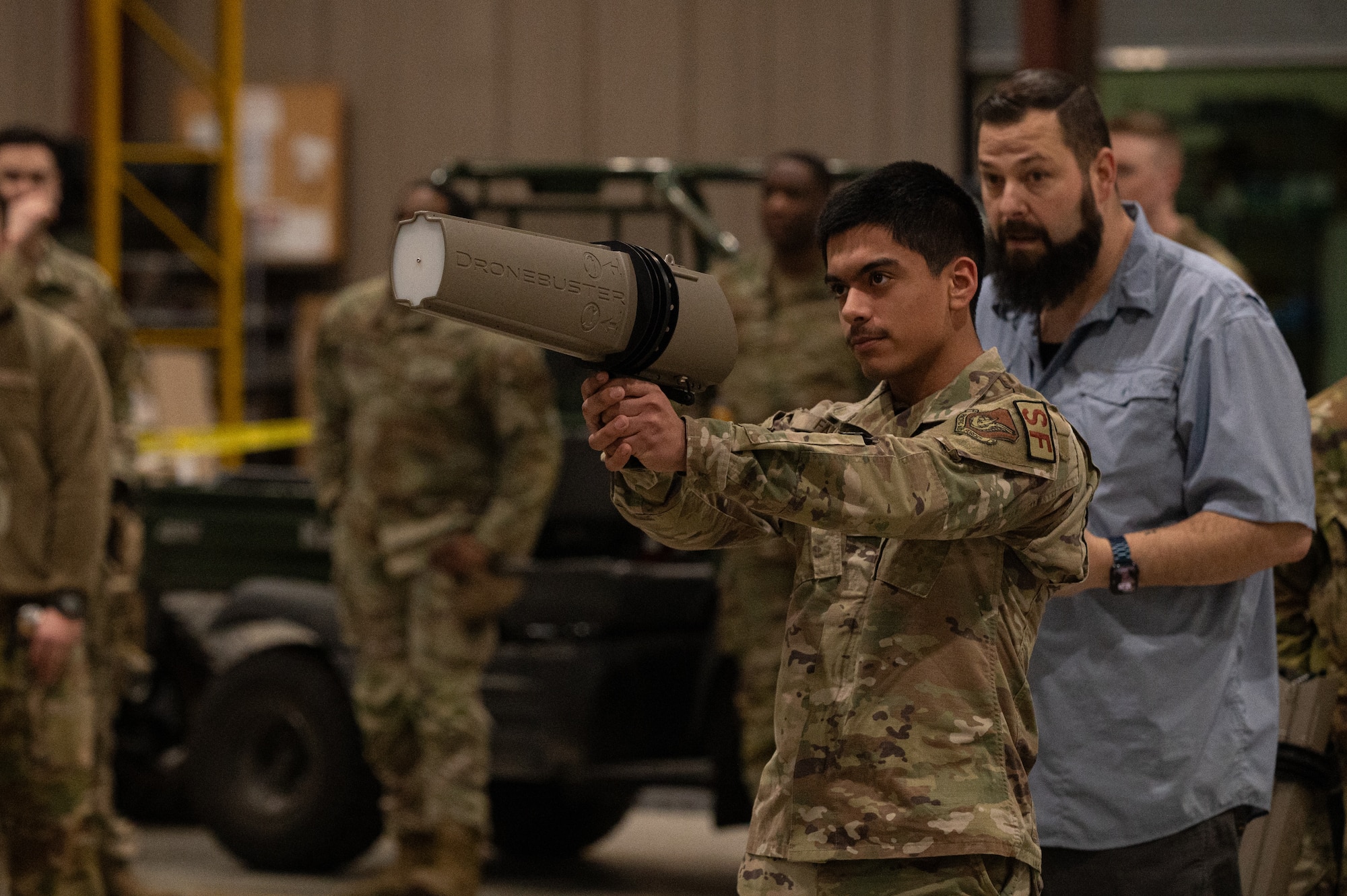 U.S. Air Force Airman Derek Falcon, 673d Security Forces Squadron Defender, uses a Dronebuster on a drone during a training session at Joint Base Elmendorf-Richardson, Alaska, Jan. 28, 2026. The training process for counter-small unmanned aerial systems involves both classroom instruction and practical demonstrations with the equipment. (U.S. Air Force photo by Airman 1st Class Theodore Gowdy)