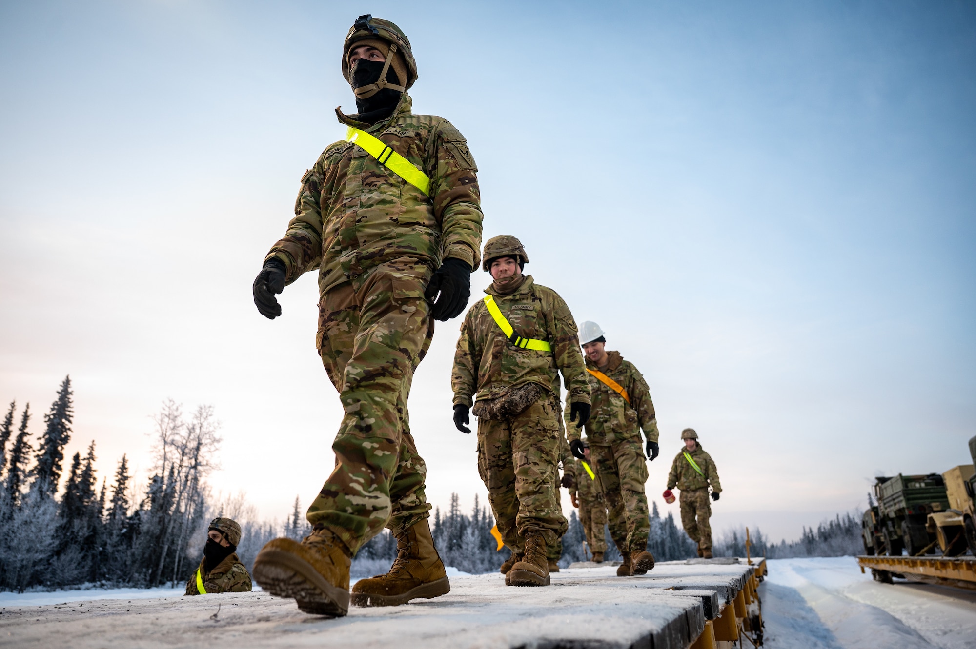 U.S. Army Soldiers assigned to the 3rd Battalion, 509th Parachute Infantry Regiment, 11th Airborne Division, prepare to clear snow from a flatcar at Joint Base Elmendorf-Richardson, Alaska, Jan. 22, 2026, in order to load freight in preparation for Joint Pacific Multinational Readiness Center 26-02. The exercise tests units’ ability to deploy, integrate and operate effectively across the Indo-Pacific region. (U.S. Air Force photo by Senior Airman Hunter Hites)
