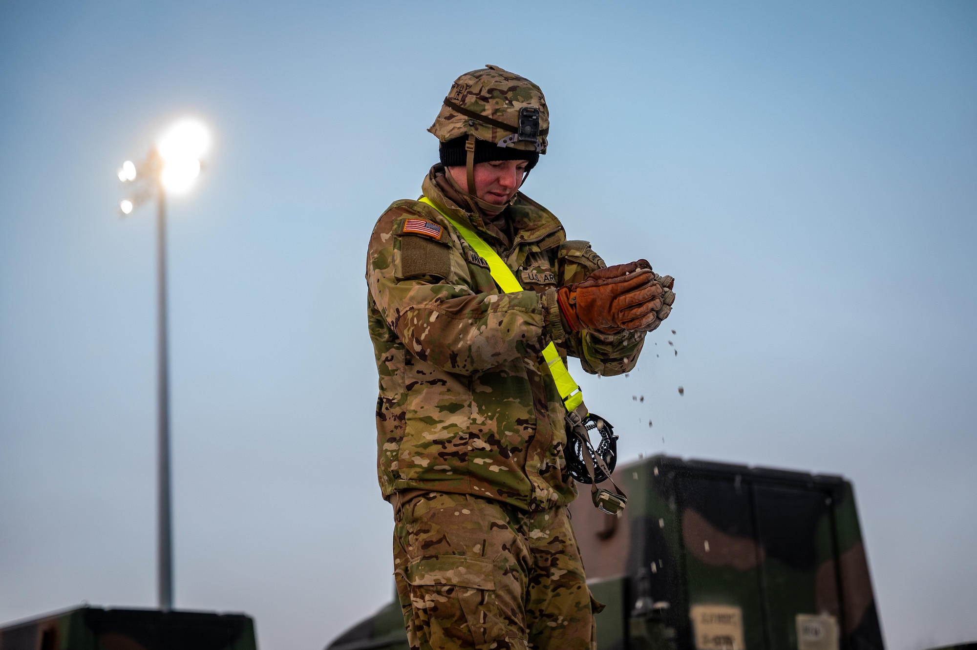 U.S. Army Spc. Clifton Van Kalsbeek, 3rd Battalion, 509th Parachute Infantry Regiment, 11th Airborne Division infantryman, lays gravel down on a flatcar at Joint Base Elmendorf-Richardson, Alaska, Jan. 22, 2026, in order to load freight in preparation for Joint Pacific Multinational Readiness Center 26-02. The exercise tests units’ ability to deploy, integrate and operate effectively across the Indo-Pacific region. (U.S. Air Force photo by Senior Airman Hunter Hites)