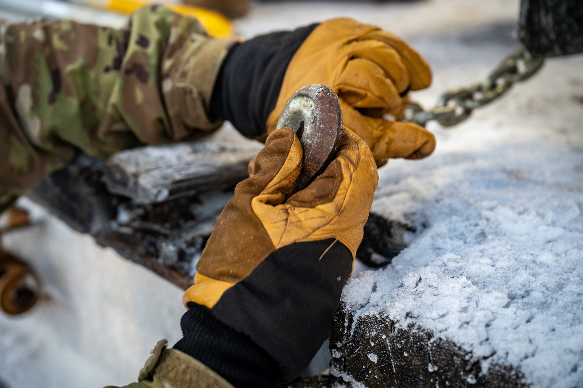 A U.S. Army Soldier assigned to the 3rd Battalion, 509th Parachute Infantry Regiment, 11th Airborne Division, secures vehicles on a flatcar at Joint Base Elmendorf-Richardson, Alaska, Jan. 22, 2026, in preparation for Joint Pacific Multinational Readiness Center 26-02. Rail loading enables the rapid movement of personnel and equipment, ensuring unit readiness and ability to deploy efficiently for large-scale training exercises. (U.S. Air Force photo by Senior Airman Hunter Hites)