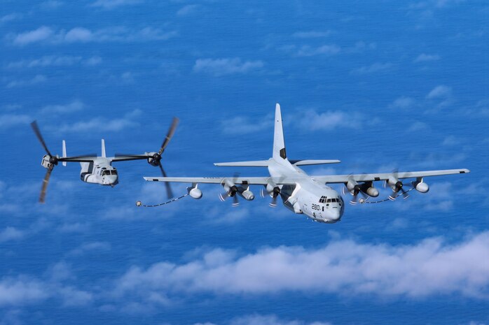 A U.S. Marine Corps MV-22B Osprey assigned to Marine Medium Tiltrotor Squadron (VMM) 268, Marine Aircraft Group 24, 1st Marine Aircraft Wing, flies alongside a KC-130J assigned to Marine Aerial Refueler Transport Squadron 153 during a flight over the Pacific Ocean, Jan 27, 2026.