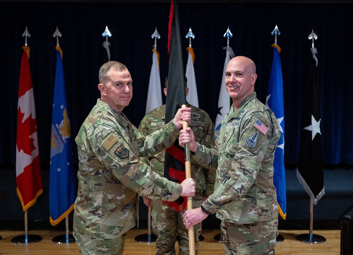 Gen. Gregory Guillot, North American Aerospace Defense Command and U.S. Northern Command commander passes the guidon emblazoned with the Space Forces-Northern emblem to Brig. Gen. Robert Schreiner, SPACEFOR-NORTH commander during the SPACEFOR-NORTH activation ceremony at Peterson SFB, Colo., Jan 30, 2026. U.S. Space Forces Northern, serves as the Space Force service component to U.S. Northern Command. (U.S. Space Force photo by John Ayre)