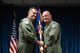 Lt. Col. Josh Ketterer, right, accepts the 123rd Operations Group guidon from Col. Matthew Quenichet, 123rd Airlift Wing commander, during a change-of-command ceremony at the Kentucky Air National Guard Base in Louisville, Ky., Dec. 14, 2025. Ketterer replaces Col. Randall Hood, who was named deputy commander of the 123rd Airlift Wing. (U.S. Air National Guard photo by Tech. Sgt. Chloe Ochs)
