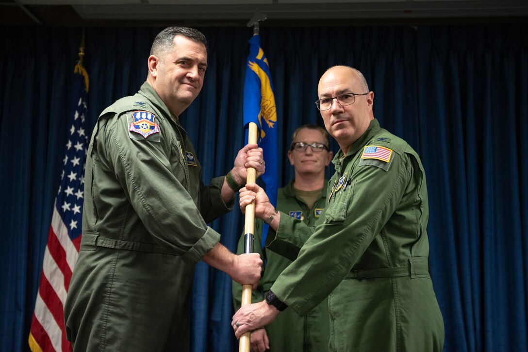 Col. Randall Hood, right, relinquishes the 123rd Operations Group guidon to Col. Matthew Quenichet, 123rd Airlift Wing commander, during a change-of-command ceremony at the Kentucky Air National Guard Base in Louisville, Ky., Dec. 14, 2025. Lt. Col. Josh Ketterer is replacing Hood, who has been named deputy wing commander. (U.S. Air National Guard photo by Tech. Sgt. Chloe Ochs)