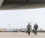 Lt. Gen. Clark Quinn, Air Education and Training Command commander,  and Lt. Col. Jonathan Aronoff, 416th Flight Test Squadron T-7 lead test pilot, walk toward a T-7 Red Hawk.