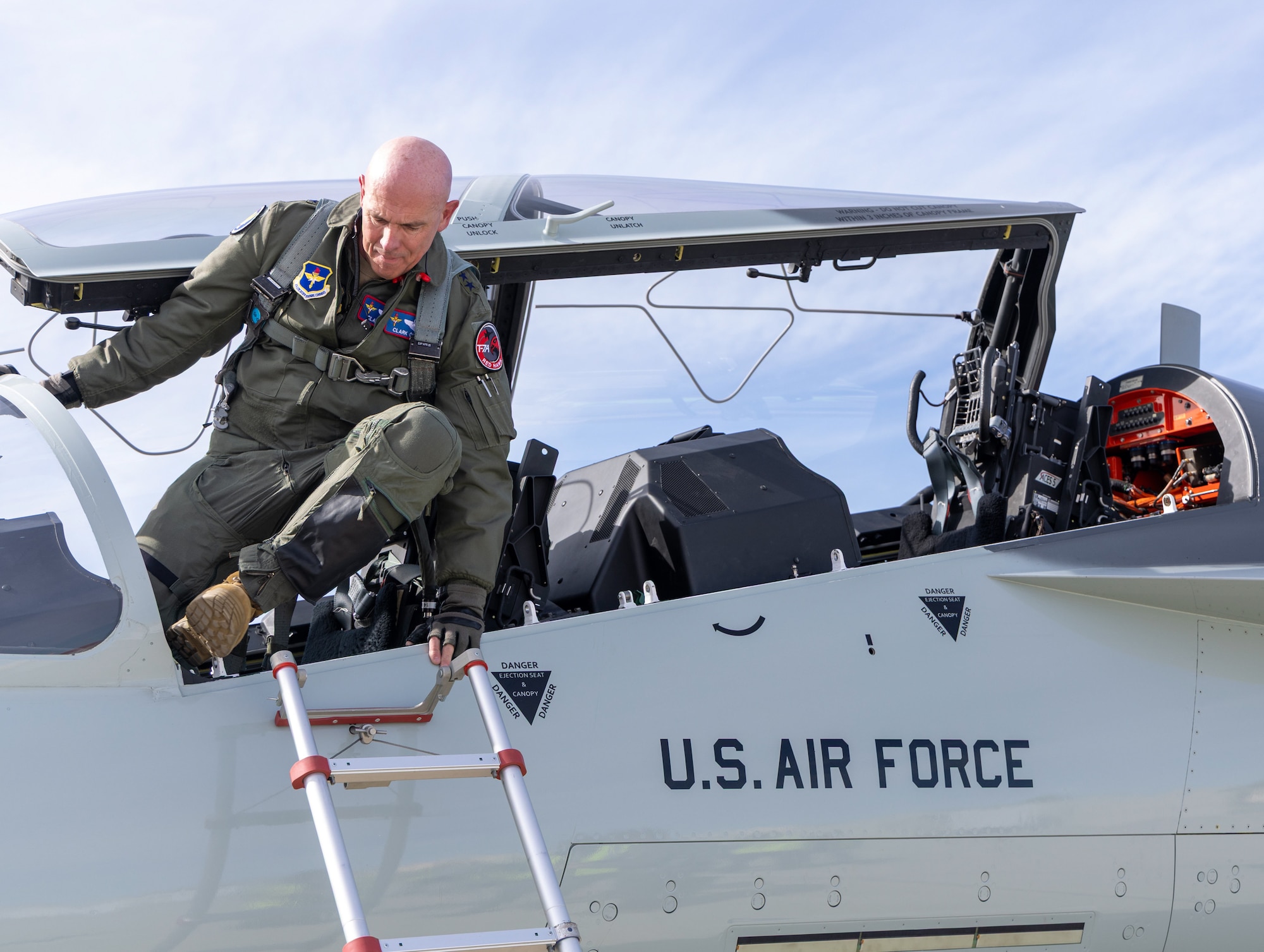Lt. Gen. Clark Quinn, Air Education and Training Command commander, climbs out of a T-7 Red Hawk.