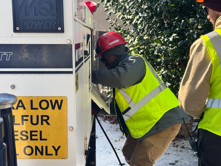 A man is working on a generator