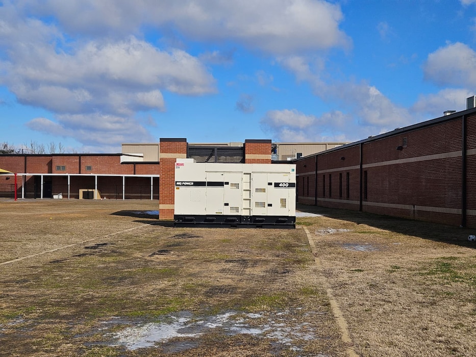 a large generator sits next to a school.