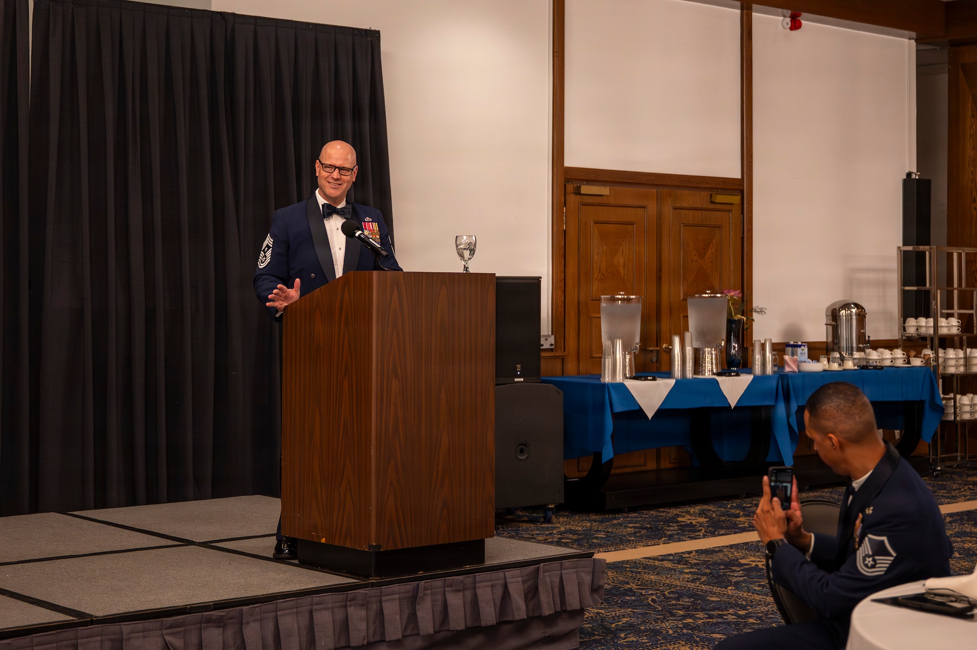 A photo of an Airman giving a speech