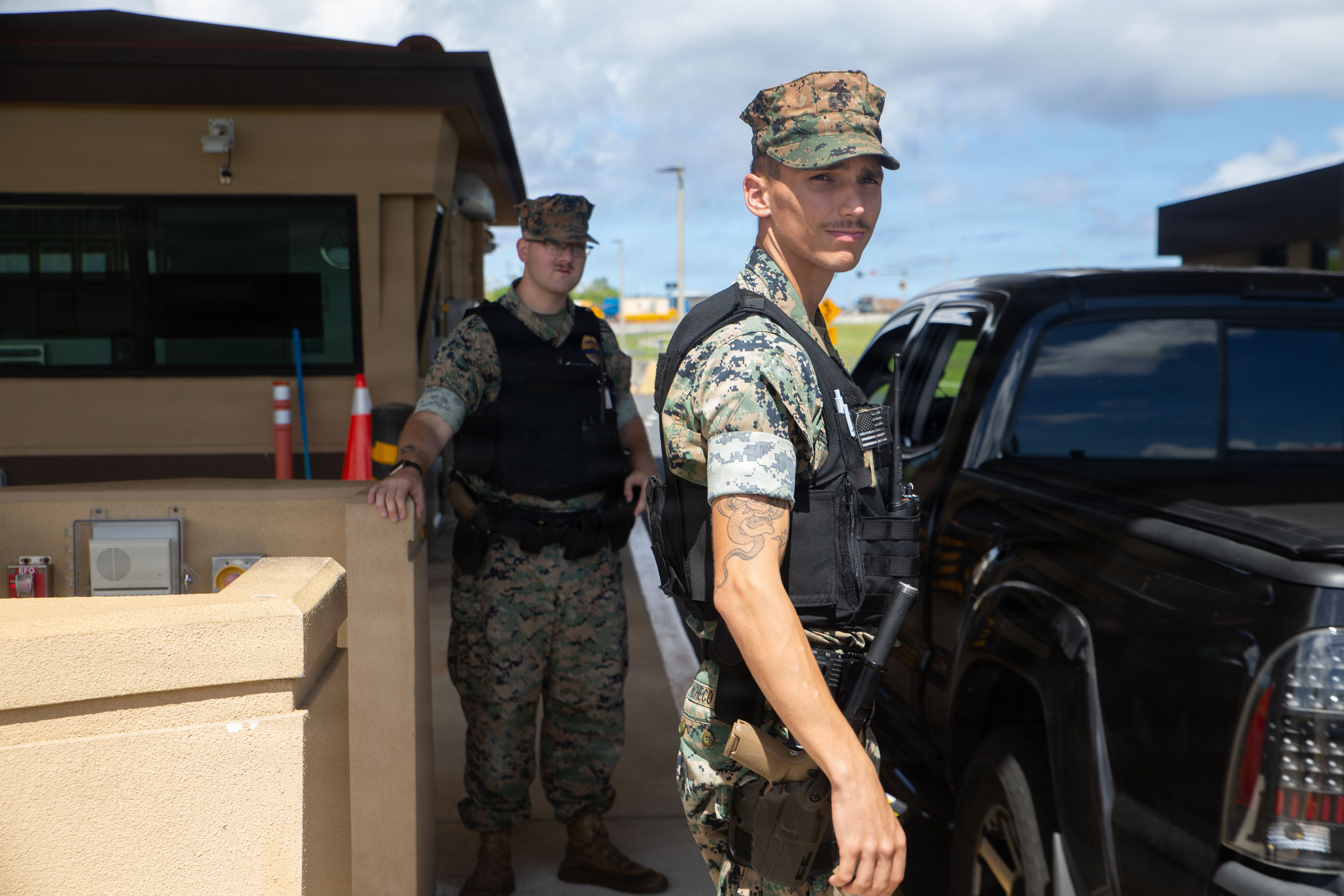 U.S. Marine Corps Pfc. Dillon Tripp, military police officer, and Lance Cpl. Preston Pacheco, military police officer, both with Headquarters Company, Marine Corps Base Camp Blaz, conduct I.D. checks at a Camp Blaz gate, MCB Camp Blaz, Guam, June 30, 2026. The MCB Camp Blaz Provost Marshal’s Office has recently achieved initial operation capable status and continues to expand their efforts throughout the installation. (U.S. Marine Corps photo by Lance Cpl. Tanner Currin)