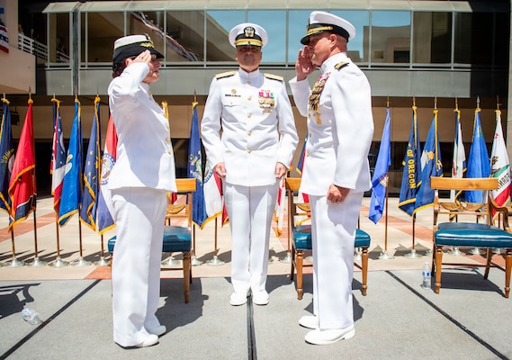 Rear Adm. Kevin J. Brown, commander, Naval Medical Forces Pacific, and director, Defense Health Network Pacific Rim, prepares to conduct the transfer of leadership between Capt. Elizabeth Adriano and Capt. Jerry J. Bailey during the Navy Medicine Readiness and Training Command (NMRTC) San Diego change of command and Naval Medical Center San Diego (NMCSD) transfer of directorship ceremony at NMCSD, June 30, 2026. The ceremony marked Bailey's assumption of duties as director of NMCSD, succeeding Adriano. NMRTC San Diego supports Navy and Marine Corps readiness by ensuring its medical forces are ready to deploy and provide medical support, ashore or at sea. The mission of NMCSD is to optimize health and enhance readiness. NMCSD employs more than 5,500 active-duty military personnel, civilians, and contractors in southern California to deliver exceptional care afloat and ashore. (U.S. Navy photo by Mass Communication Specialist 1st Class Marcus Stanley)